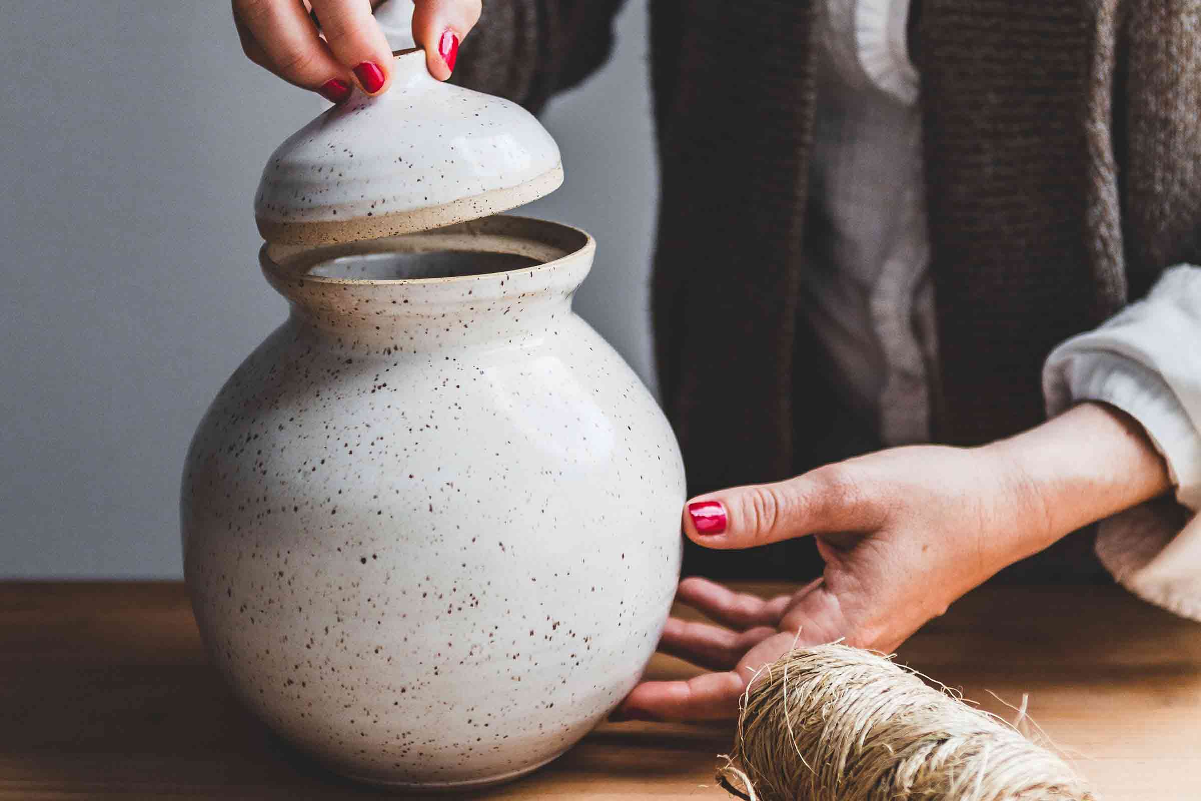 A woman holding a pot.