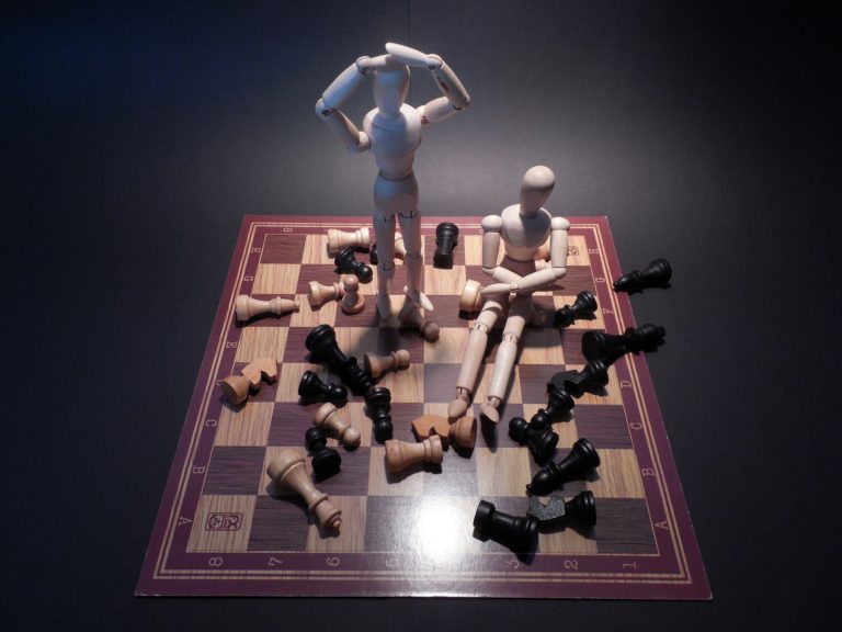 Some dolls playing chess.