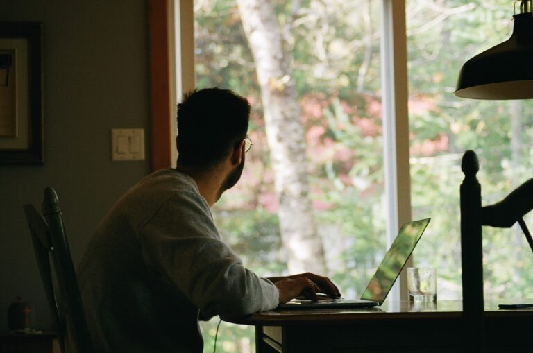 A man working at a computer at home.
